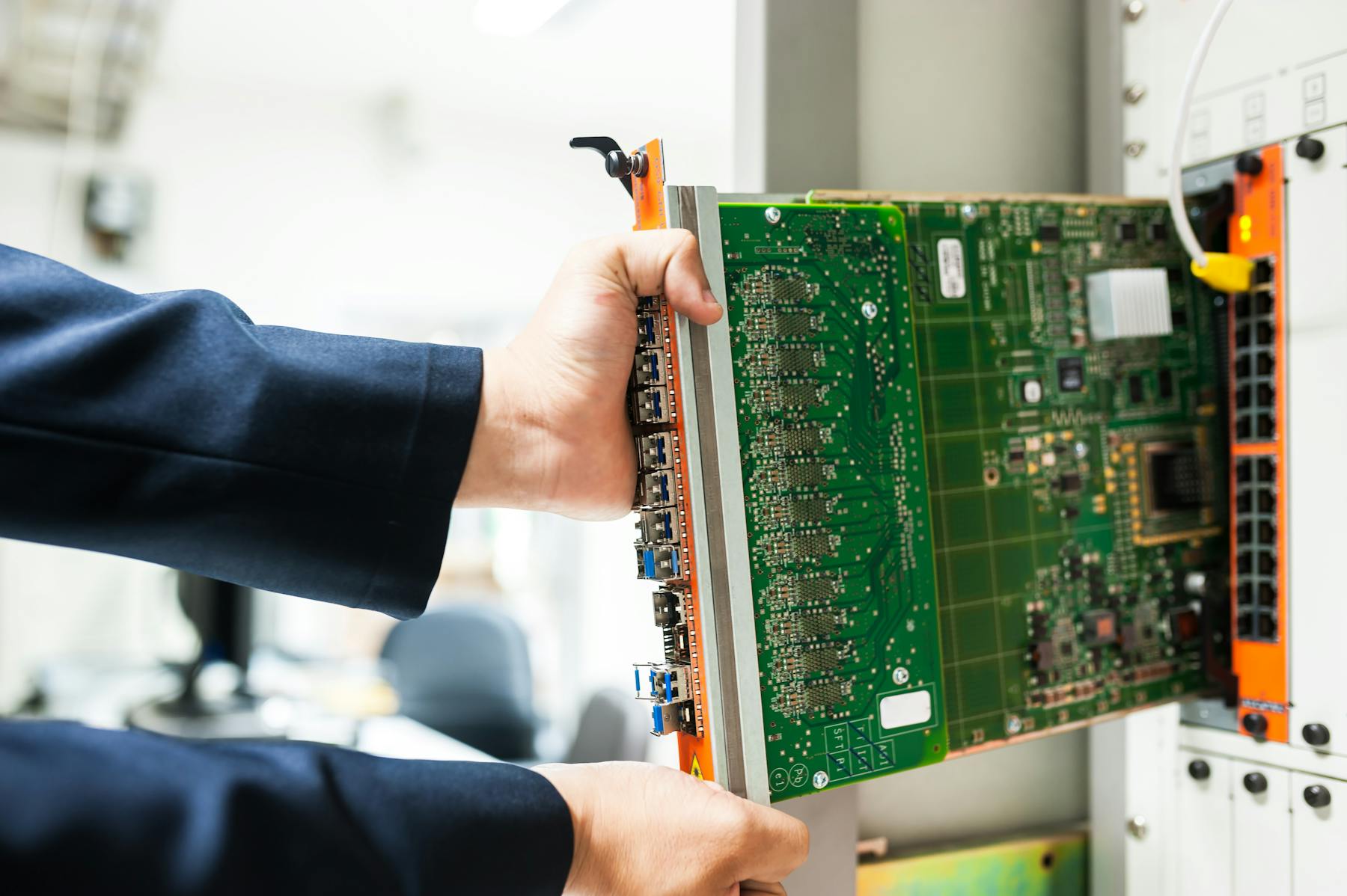 Technician installing edge infrastructure in a network rack
