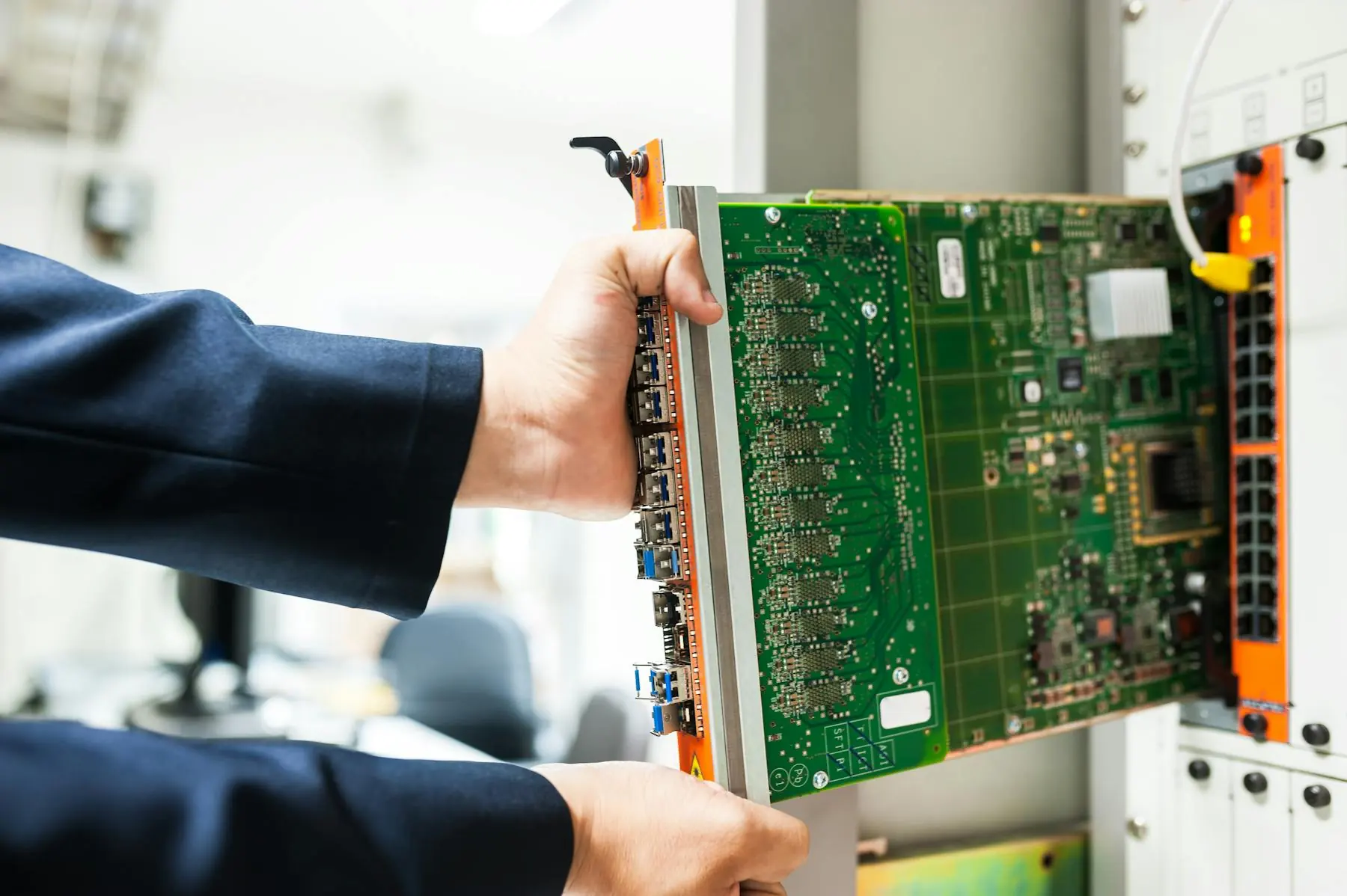 Technician installing hardware inside a network and edge infrastructure rack