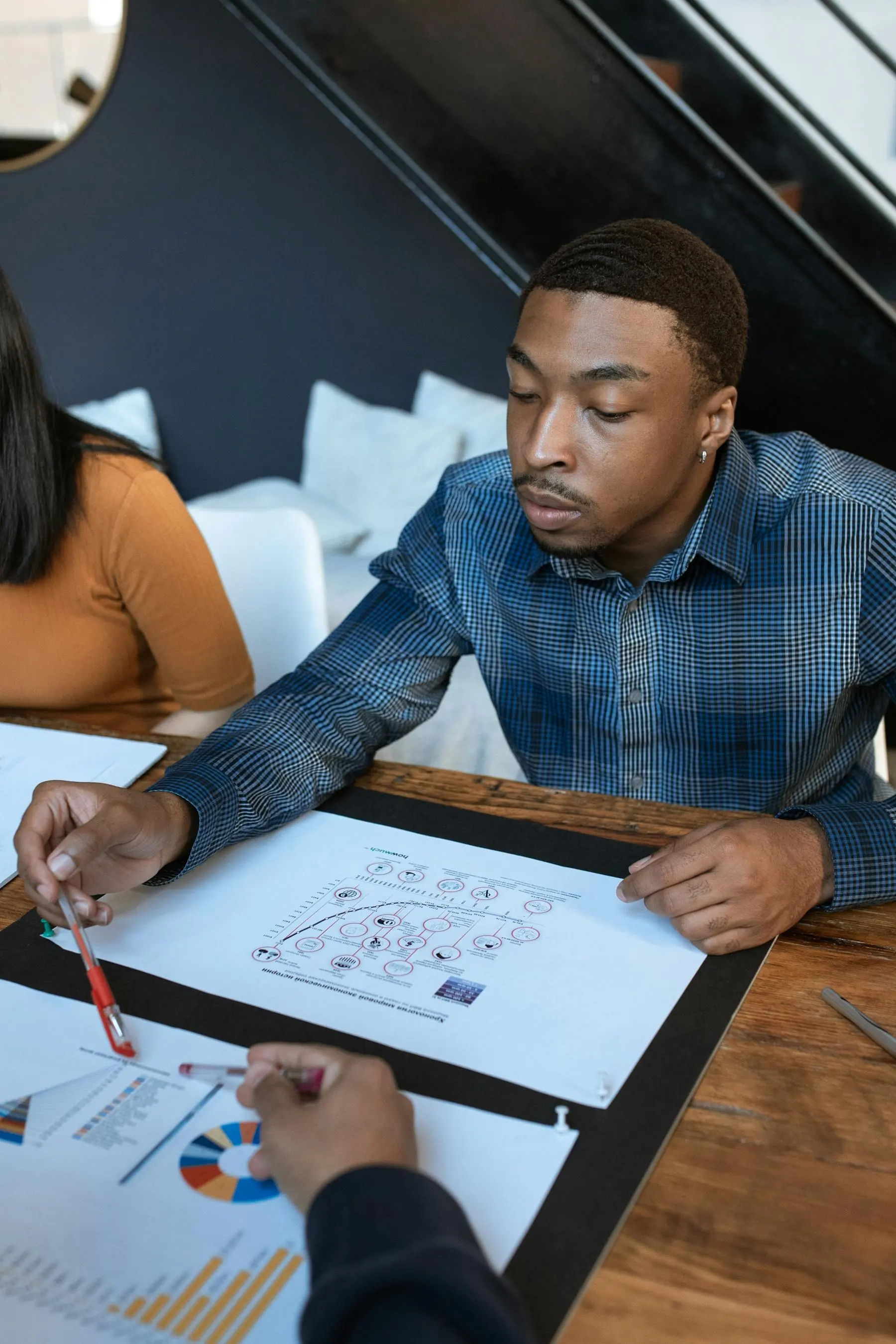 Business team reviewing printed analytics and strategy documents in a professional office