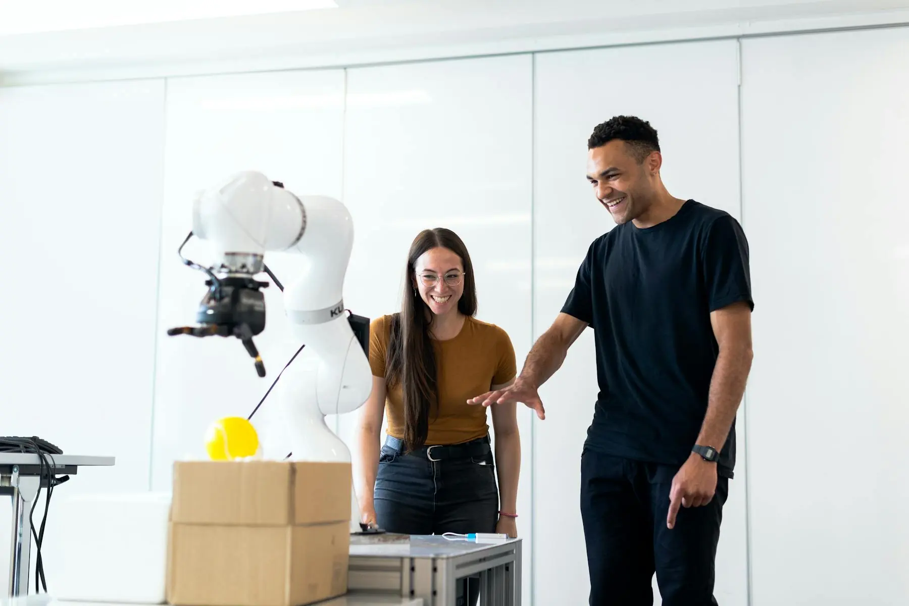 Engineers testing a robot in an industrial research and integration laboratory