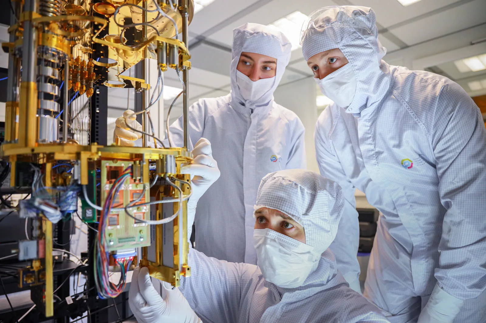 Researchers inspecting cryogenic quantum hardware in a bright laboratory, representing controlled measurement and error-mitigation experiments