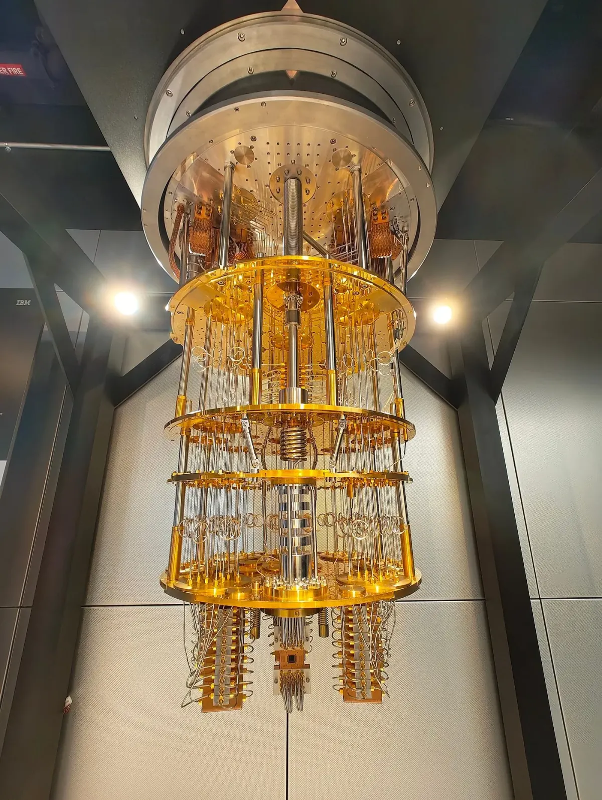 IBM quantum computer dilution refrigerator with exposed gold-coloured cryogenic wiring and support plates